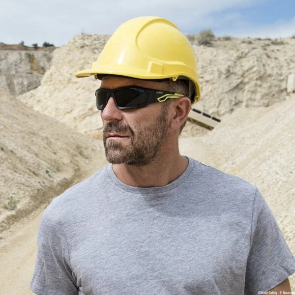 A man wearing workwear and safety boots.